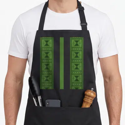 Tablier de cuisine noir avec bandes vertes à motifs géométriques noirs et étoiles stylisées.
