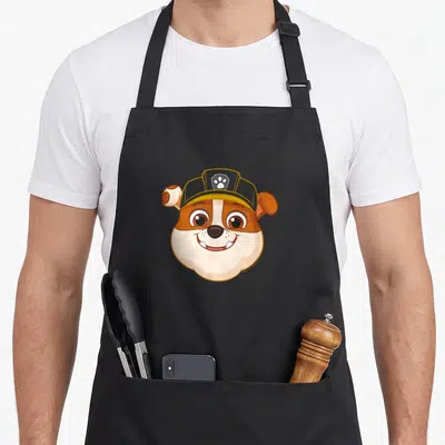 Tablier de cuisine noir avec l'illustration du chien Rubble en vampire souriant.