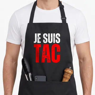 Tablier de cuisine noir avec l'inscription Je suis TAC en blanc et rouge.