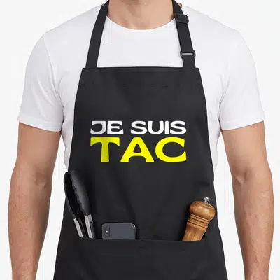 Tablier de cuisine noir avec l'inscription Je Suis TAC en lettres blanches et jaunes vives.