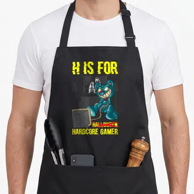 Tablier de cuisine noir avec un ours bleu terrifiant et le texte H Is For Hardcore Gamer imprimé en jaune.