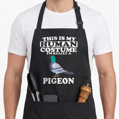 Tablier de cuisine noir avec illustration d'un pigeon et texte blanc This is my human costume I'm really a pigeon
