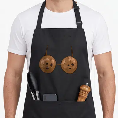 Tablier de cuisine noir avec illustration d'un soutien-gorge formé par deux noix de coco aux visages expressifs et des bretelles brunes.