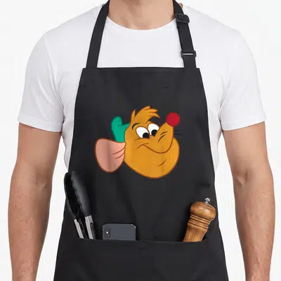 Tablier de cuisine noir avec illustration colorée du visage de Gus le souris aux yeux rieurs et nez rouge.