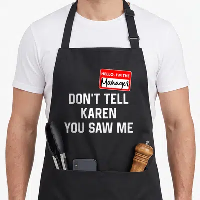 Tablier de cuisine noir avec autocollant rouge Hello I'm the Manager et texte blanc Don't Tell Karen You Saw Me