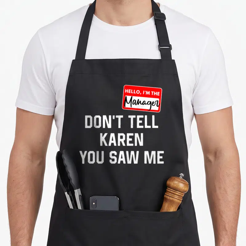 Tablier de cuisine noir avec autocollant rouge Hello I'm the Manager et texte blanc Don't Tell Karen You Saw Me