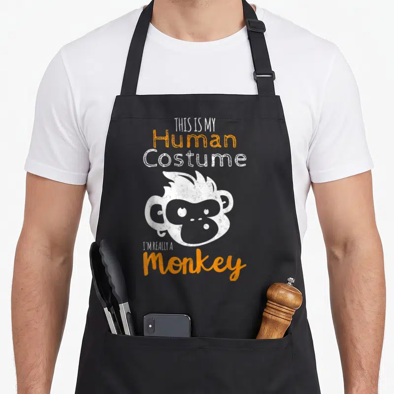 Tablier de cuisine noir avec illustration d'un singe blanc et texte orange This is My Human Costume I'm Really A Monkey.