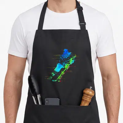 Tablier de cuisine noir avec joueur de hockey coloré aux teintes néon et lignes dynamiques évoquant la vitesse.