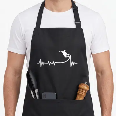Tablier de cuisine noir avec silhouette blanche de skateur effectuant un saut au-dessus d'une ligne de rythme cardiaque stylisée.