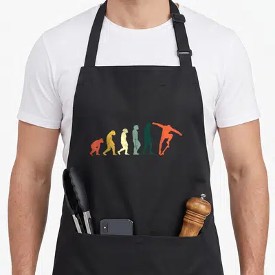 Tablier de cuisine noir avec silhouette évolutive passant de la quadrupédie au skater sur planche à roulettes.