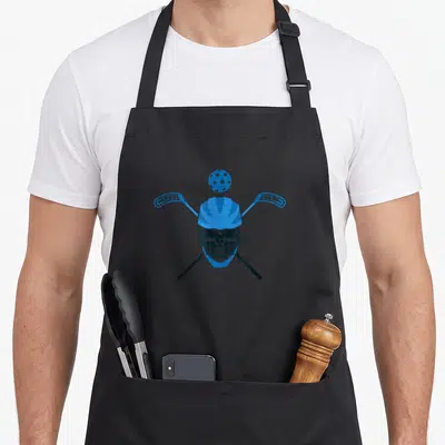Tablier de cuisine noir avec un crâne en casque bleu, une balle de floorball et des crosses croisées.