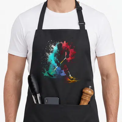 Tablier de cuisine noir avec silhouette d'hockeyeur en éclaboussures turquoise, rouge et bleue.