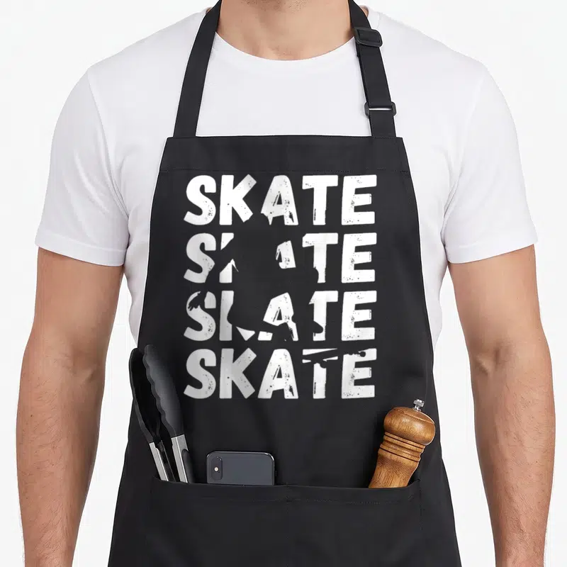 Tablier de cuisine noir avec le texte Skate écrit quatre fois en blanc avec effet dégradé et usé.