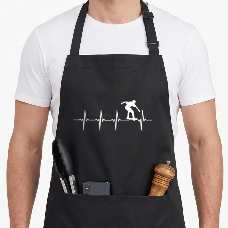 Tablier de cuisine noir avec silhouette blanche skateboarder sur une ligne de battement de coeur.