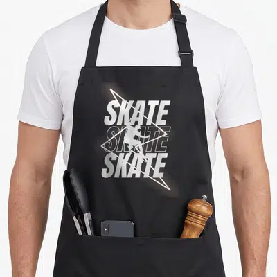 Tablier de cuisine noir avec illustration blanche d'un skateur et du texte Skate Skateboard Rider superposé à des lignes géométriques.