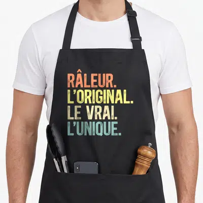 Tablier de cuisine noir avec inscription colorée râleur l'original le vrai l'unique en style vintage dégradé.