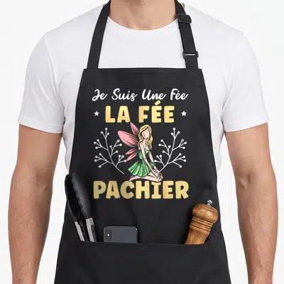 Tablier de cuisine noir avec une fée aux ailes roses et l'inscription Je Suis Une Fée La Fée Pachier en lettres jaunes.