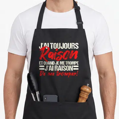 Tablier de cuisine noir avec l'inscription j'ai toujours raison et quand je me trompe j'ai raison de me tromper en rouge et blanc.