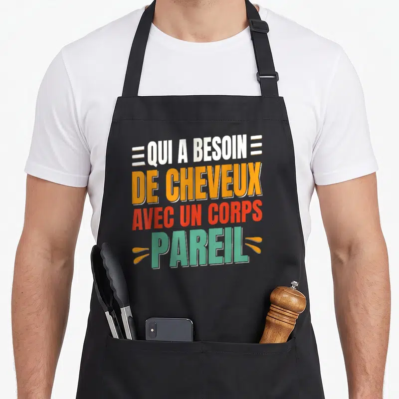 Tablier de cuisine noir avec l'inscription colorée Qui a besoin de cheveux avec un corps pareil en typographie moderne.