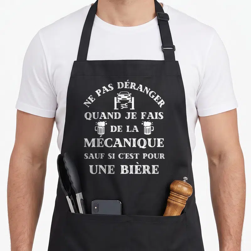 Tablier de cuisine noir avec inscription blanche ne pas déranger quand je fais de la mécanique sauf si c'est pour une bière et icône voiture sur pont levier.