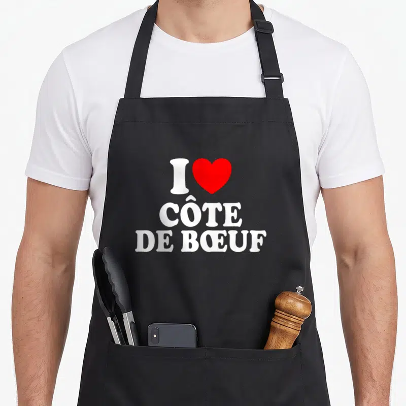 Tablier de cuisine noir avec inscription blanche I cœur rouge côte de boeuf en typographie arrondie.