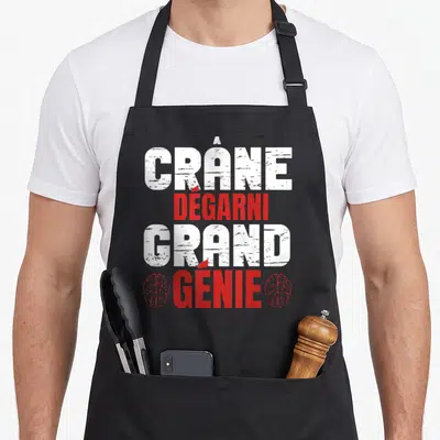 Tablier de cuisine noir avec texte crâne dégarni grand génie en blanc et rouge flanqué de deux cerveaux rouges.