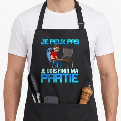 Tablier de cuisine noir avec illustration d'un gamer au PC et texte bleu Je peux pas je dois finir ma partie