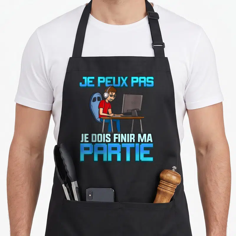 Tablier de cuisine noir avec illustration d'un gamer au PC et texte bleu Je peux pas je dois finir ma partie