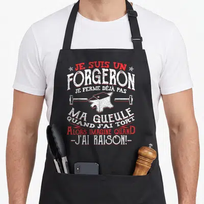 Tablier de cuisine noir avec inscription je suis un forgeron et illustration d'enclume blanche.