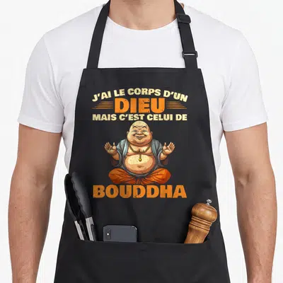 Tablier de cuisine noir avec illustration du Bouddha Riant et texte orange J'ai le corps d'un dieu mais c'est celui de Bouddha