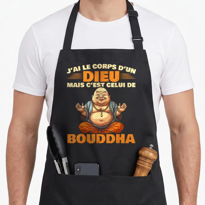 Tablier de cuisine noir avec illustration du Bouddha Riant et texte orange J'ai le corps d'un dieu mais c'est celui de Bouddha