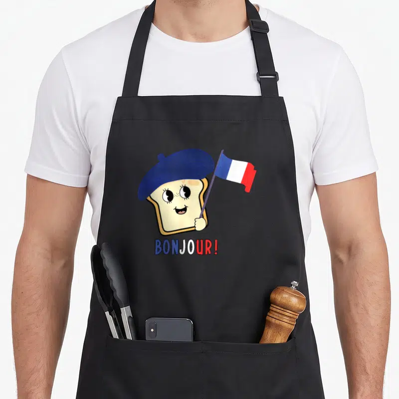 Tablier de cuisine noir avec un toast mignon portant une berline bleue et agitant un petit drapeau français sous l'inscription Bonjour.