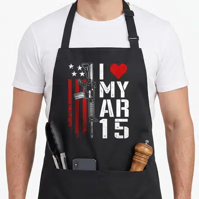Tablier de cuisine noir avec illustration de fusil AR-15, étoiles blanches et texte blanc sur fond rouge strié.