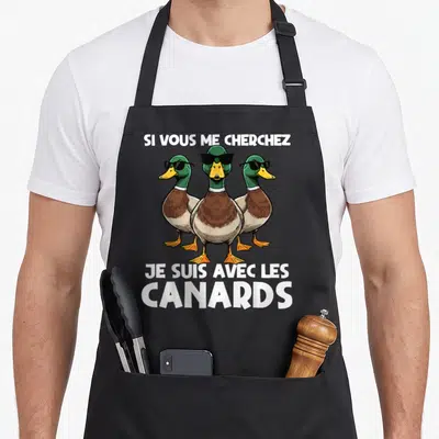 Tablier de cuisine noir avec trois canards aux lunettes noires et le texte Si vous me cherchez je suis avec les canards