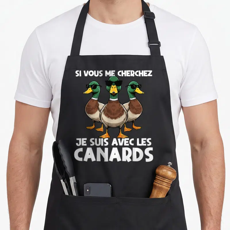 Tablier de cuisine noir avec trois canards aux lunettes noires et le texte Si vous me cherchez je suis avec les canards