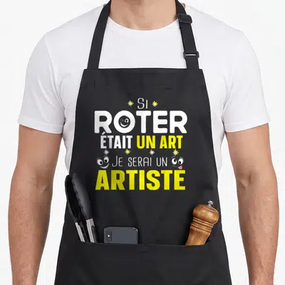 Tablier de cuisine noir avec le texte Si roter était un art je serai un artiste en blanc et jaune.