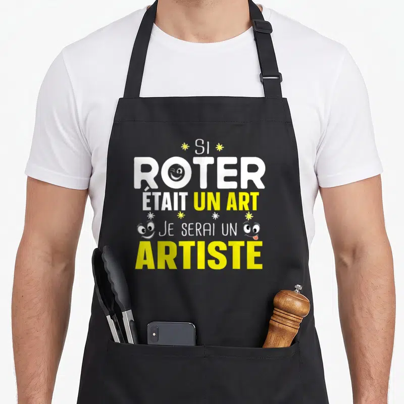 Tablier de cuisine noir avec le texte Si roter était un art je serai un artiste en blanc et jaune.