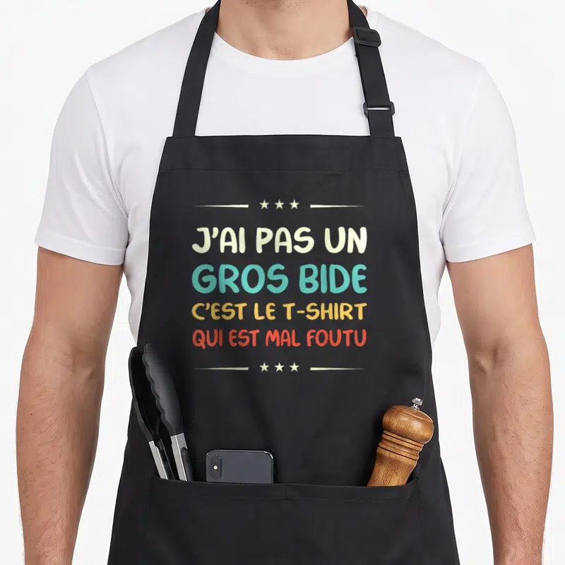 Tablier de cuisine noir avec inscription humoristique J'ai pas un gros bide en lettres colorées sur fond uni.