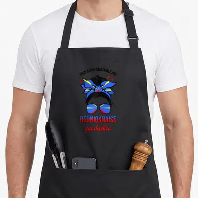 Tablier de cuisine noir avec illustration femme lunettes et chignon aux couleurs du drapeau réunionnais