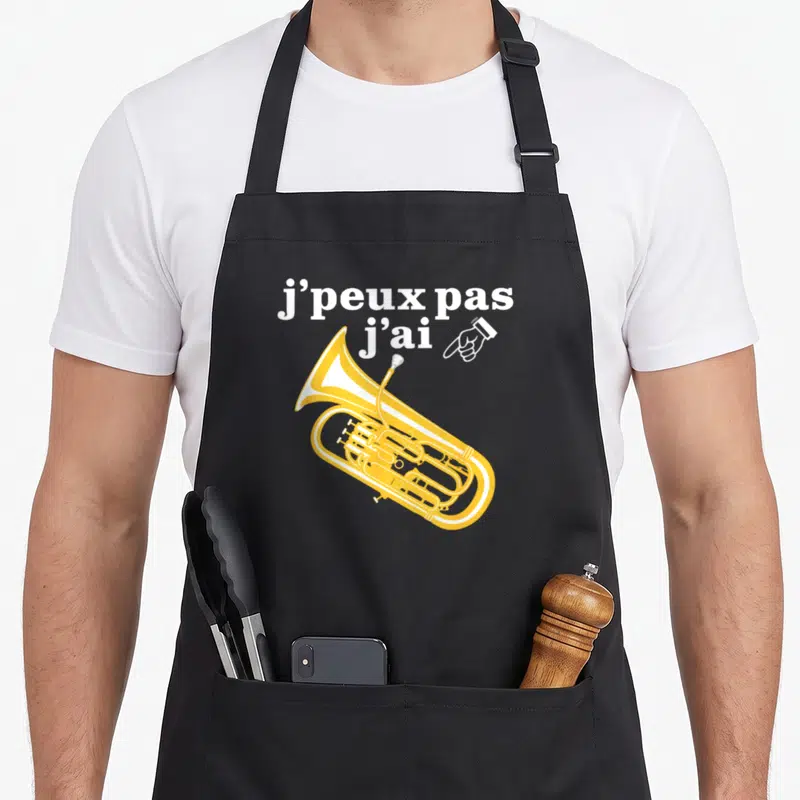 Tablier de cuisine noir avec illustration d'un euphonium jaune et texte blanc J'peux pas j'ai pointant vers l'instrument.