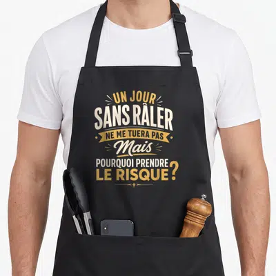 Tablier de cuisine noir avec inscription Un jour sans râler ne me tuera pas mais pourquoi prendre le risque en blanc et or.