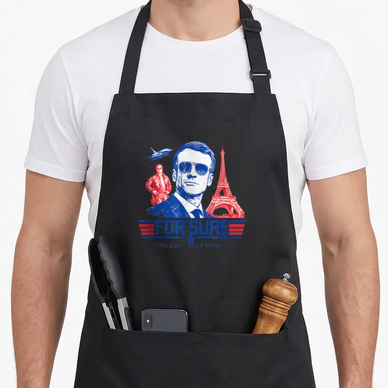 Tablier de cuisine noir avec illustration parodique d'un homme en lunettes de soleil et la mention For Sure President of la France.