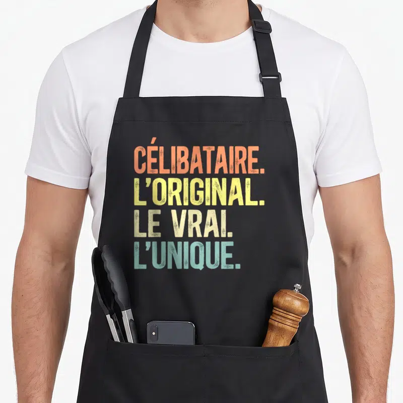 Tablier de cuisine noir avec texte célibataire original le vrai l'unique en lettres dégradées orange jaune et bleu turquoise style rétro.