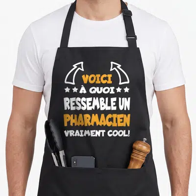 Tablier de cuisine noir avec inscription voici à quoi ressemble un pharmacien vraiment cool en orange et blanc.