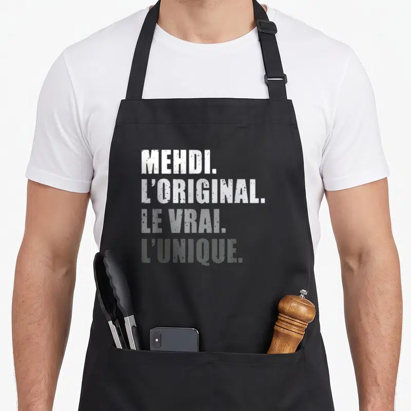 Tablier de cuisine noir avec inscription Mehdi l'original le vrai l'unique en typographie blanche dégradée.