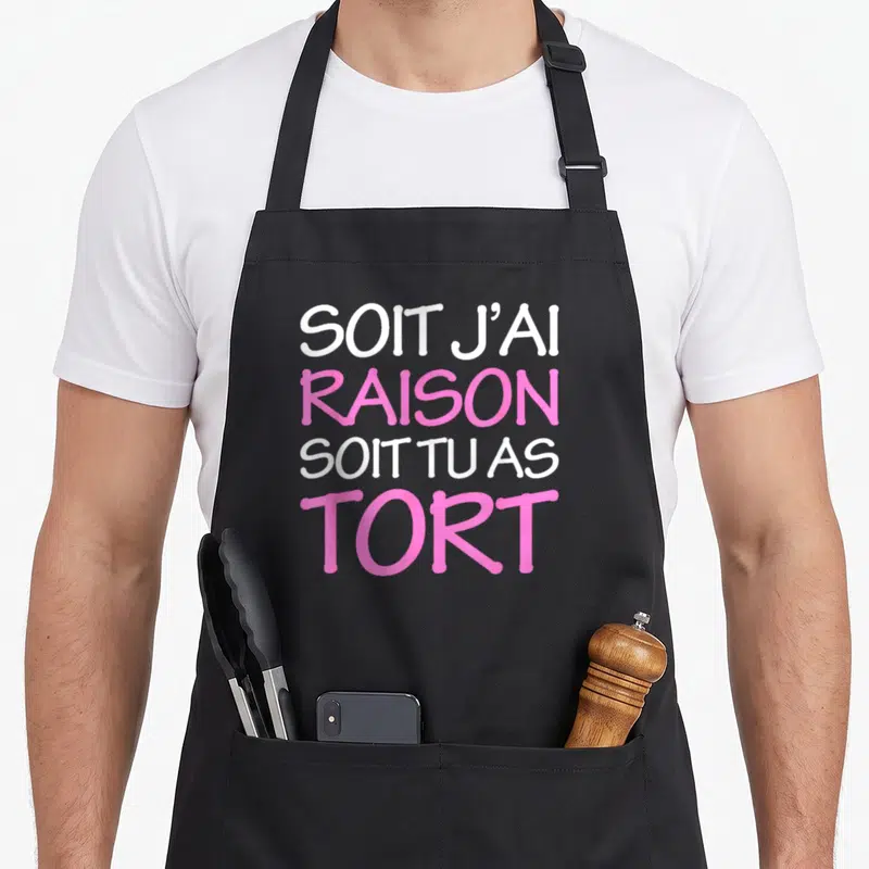 Tablier de cuisine noir avec l'inscription Soit j'ai raison soit tu as tort en rose et blanc.