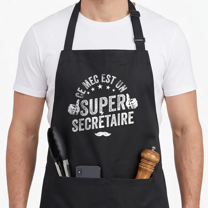 Tablier de cuisine noir avec inscription Ce mec est un super secrétaire et deux pouces levés en blanc.