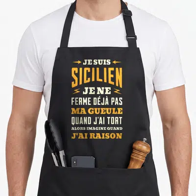 Tablier de cuisine noir avec l'inscription Je suis Sicilien ma gueule quand j'ai raison en orange et blanc.