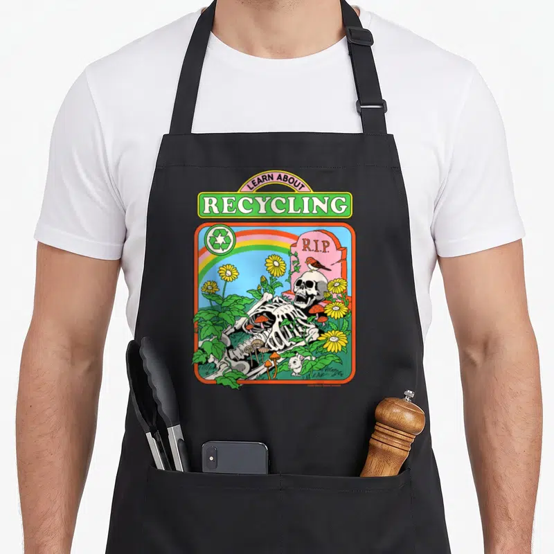 Tablier de cuisine noir avec illustration rétro d'un squelette sous arc-en-ciel et l'inscription Learn About Recycling en haut.