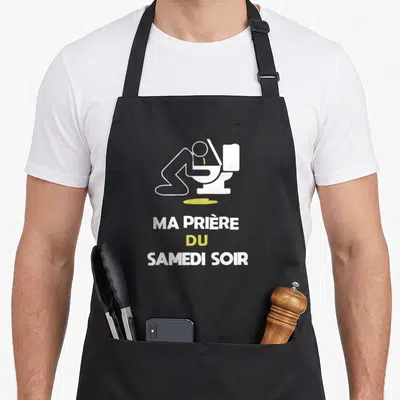 Tablier de cuisine noir avec silhouette blanche sur un WC et texte Ma prière du samedi soir